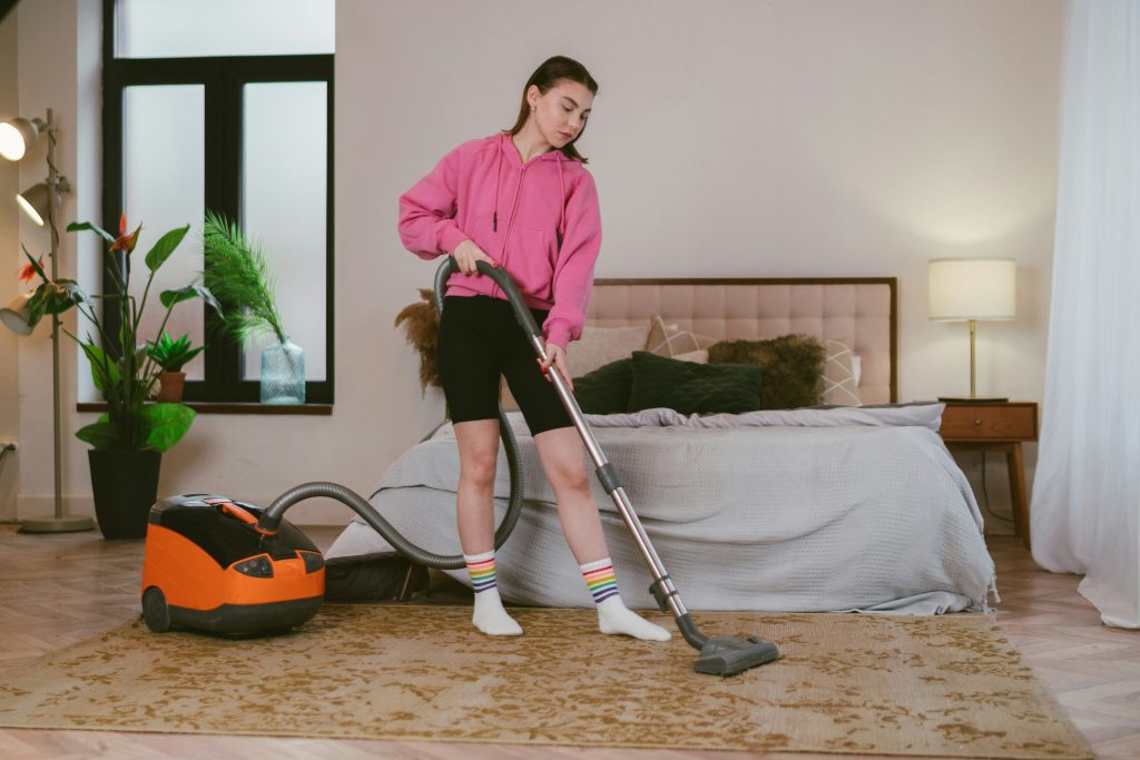 Woman vacuuming carpet