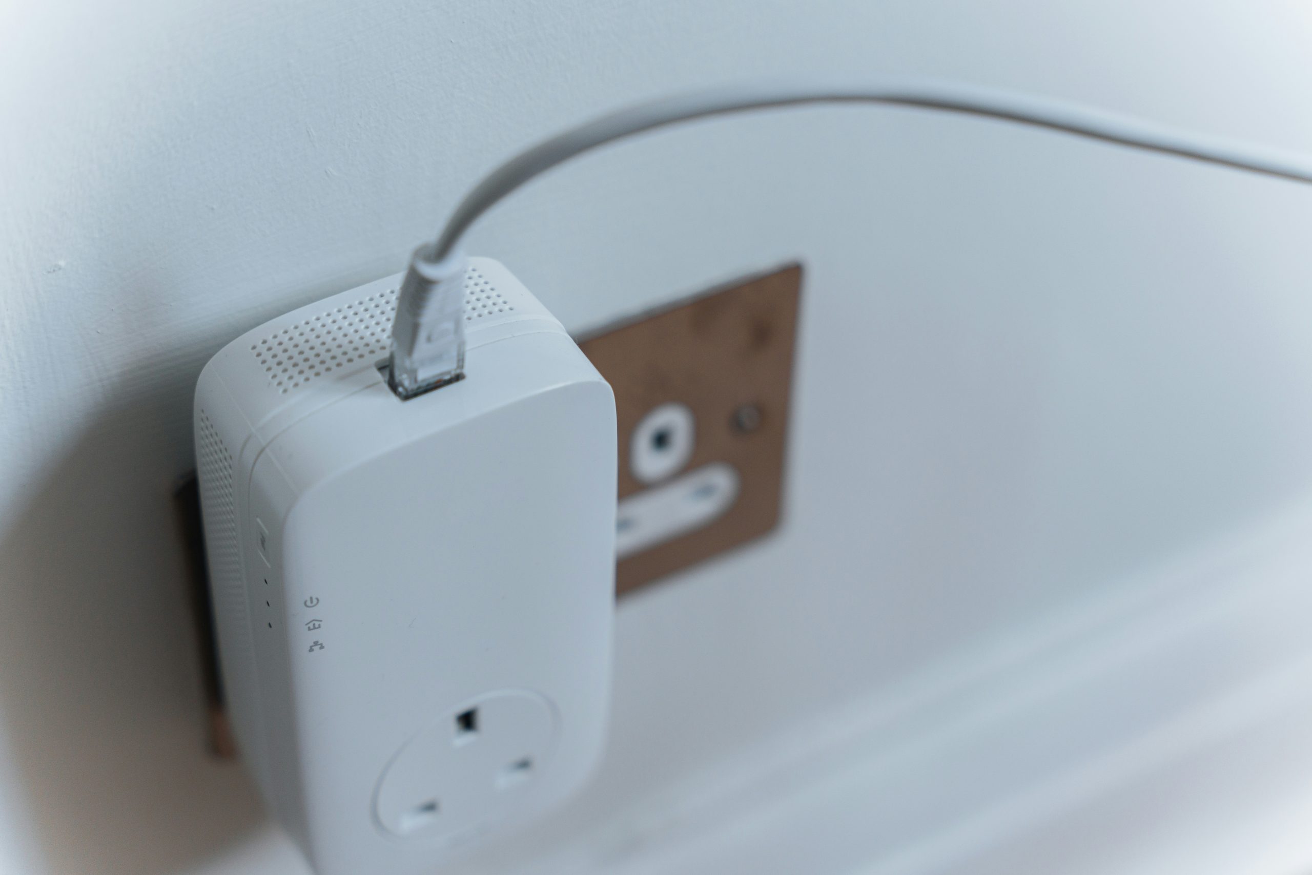 White device plugged into electric outlet