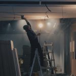 Man working in basement on ladder