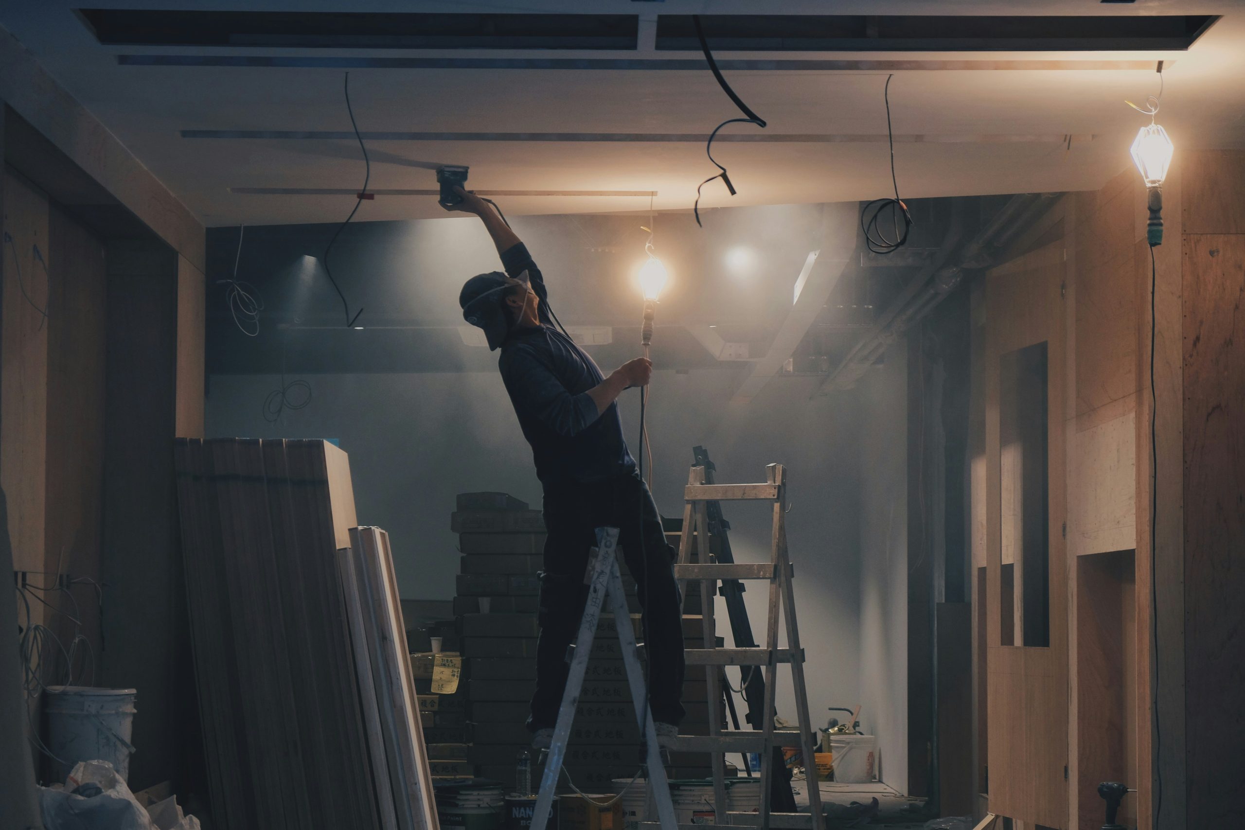 Man working in basement on ladder